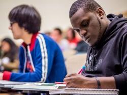 Photo of a student writing in a notebook